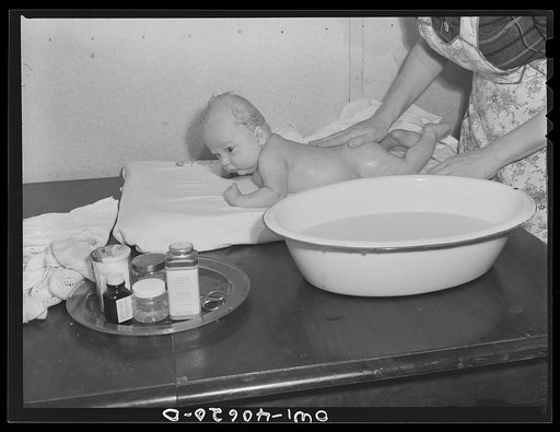 Washington, D.C. Eight weeks old Joey Massman, infant son of a petty officer, second class, who is studying in Washington, D.C., getting his daily bath