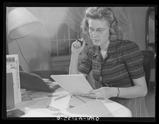 Untitled photo, possibly related to: Washington, D.C. Lynn Massman, wife of a second class petty officer who is studying in Washington, writing letters while her baby is having his afternoon nap