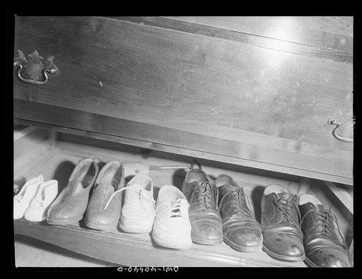 Untitled photo, possibly related to: Washington, D.C. Bureau and shoes in the room of Hugh Massman, a second class petty officer who is studying in Washington, and his wife
