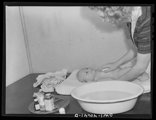Washington, D.C. Lynn Massman, wife of a second class petty officer studying in Washington, D.C. giving eight weeks old Joey his daily bath