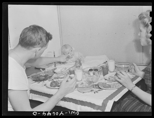 Washington, D.C. Hugh Massman, a second class petty officer who is studying in Washington, D.C. and his wife eating dinner. Joey, their son, sleeps on a pad on the table