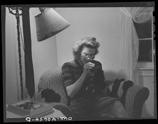 Untitled photo, possibly related to: Washington, D.C. Lynn Massman, wife of a second class petty officer studying in Washington, D.C., darns socks in the afternoon while baby Joey has his nap