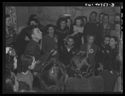 Untitled photo, possibly related to: Washington, D.C. Pete Seeger, noted folk singer, leading the crowd in "When We March into Berlin" at the opening of the Washington labor canteen, sponsored by the United Federal Workers of American, Congress of Industrial Organizations (CIO)