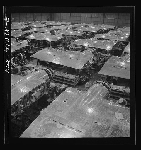 Untitled photo, possibly related to: Boeing aircraft plant, Seattle, Washington. Production of B-17F (Flying Fortress) bombing planes. Wing section, each containing two Wright engines, await mating with fuselage section of the B-17F (Flying Fortress) bomber