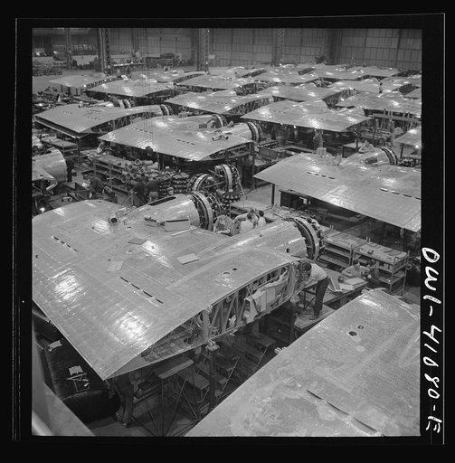 Untitled photo, possibly related to: Boeing aircraft plant, Seattle, Washington. Production of B-17F (Flying Fortress) bombing planes. Wing section, each containing two Wright engines, await mating with fuselage section of the B-17F (Flying Fortress) bomber