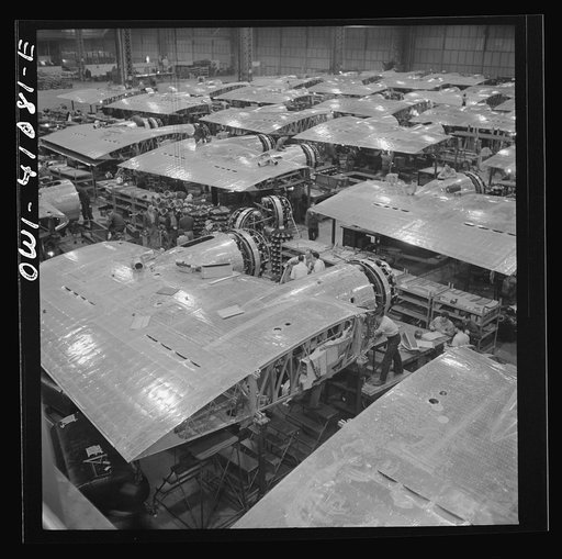 Untitled photo, possibly related to: Boeing aircraft plant, Seattle, Washington. Production of B-17F (Flying Fortress) bombing planes. Wing section, each containing two Wright engines, await mating with fuselage section of the B-17F (Flying Fortress) bomber