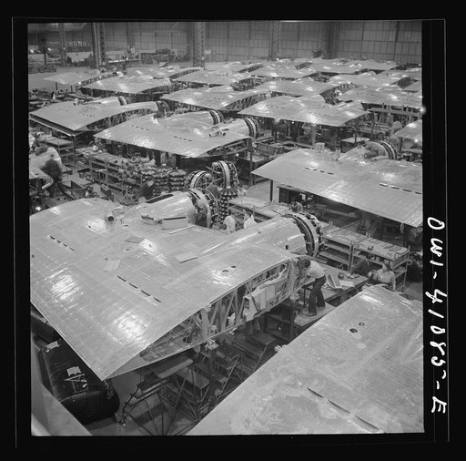 Untitled photo, possibly related to: Boeing aircraft plant, Seattle, Washington. Production of B-17F (Flying Fortress) bombing planes. Wing section, each containing two Wright engines, await mating with fuselage section of the B-17F (Flying Fortress) bomber