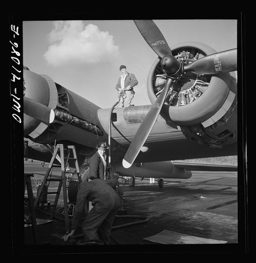 Untitled photo, possibly related to: Boeing aircraft plant, Seattle, Washington. Production of B-17F (Flying Fortress) bombing planes. Lubricating and servicing a new B-17F (Flying Fortress) bombers