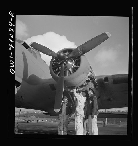Untitled photo, possibly related to: Boeing aircraft plant, Seattle, Washington. Production of B-17F (Flying Fortress) bombing planes. Lubricating and servicing a new B-17F (Flying Fortress) bomber