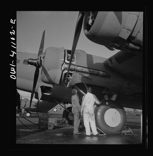 Boeing aircraft plant, Seattle, Washington. Production of B-17F (Flying Fortress) bombing planes. Lubricating and servicing a new B-17F (Flying Fortress) bombers