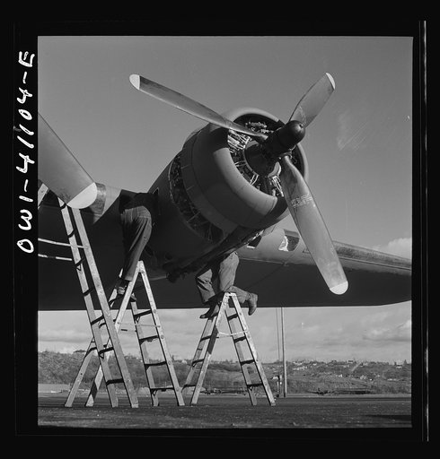 Untitled photo, possibly related to: Boeing aircraft plant, Seattle, Washington. Production of B-17F (Flying Fortress) bombing planes. Lubricating and servicing a new B-17F (Flying Fortress) bombers.