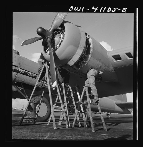 Boeing aircraft plant, Seattle, Washington. Production of B-17F (Flying Fortress) bombing planes. Lubricating and servicing a new B-17F (Flying Fortress) bombers
