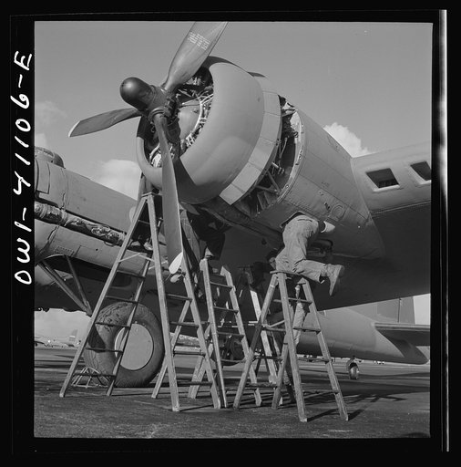 Untitled photo, possibly related to: Boeing aircraft plant, Seattle, Washington. Production of B-17F (Flying Fortress) bombing planes. Lubricating and servicing a new B-17F (Flying Fortress) bombers.