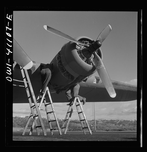 Untitled photo, possibly related to: Boeing aircraft plant, Seattle, Washington. Production of B-17F(Flying Fortress) bombing planes. Lubricating and servicing a new B-17F (Flying Fortress bombers.
