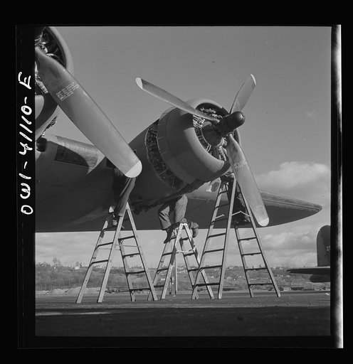 Boeing aircraft plant, Seattle, Washington. Production of B-17F(Flying Fortress) bombing planes. Lubricating and servicing a new B-17F (Flying Fortress bombers
