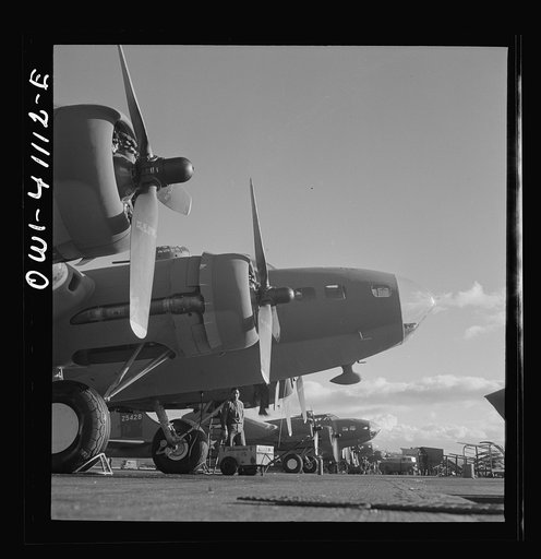Untitled photo, possibly related to: Boeing aircraft plant, Seattle, Washington. Production of B-17F (Flying Fortress) bombing planes. Lubricating and servicing a new B-17F (Flying Fortress) bombers