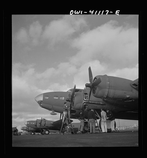 Boeing aircraft plant, Seattle, Washington. Production of B-17F (Flying Fortress) bombing planes. Lubricating and servicing a new B-17F (Flying Fortress) bombers