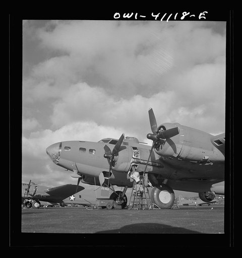 Untitled photo, possibly related to: Boeing aircraft plant, Seattle, Washington. Production of B-17F (Flying Fortress) bombing planes. Lubricating and servicing a new B-17F (Flying Fortress) bombers.