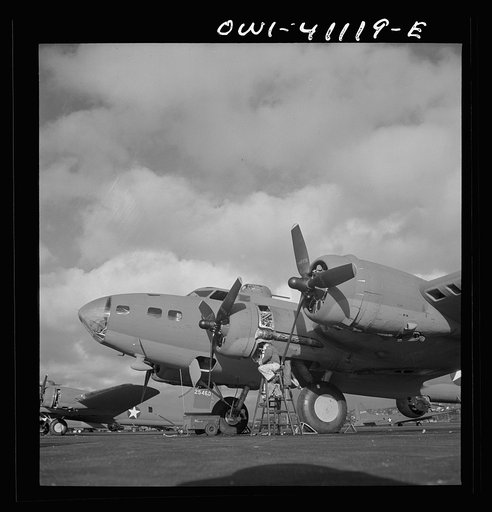 Untitled photo, possibly related to: Boeing aircraft plant, Seattle, Washington. Production of B-17F (Flying Fortress) bombing planes. Lubricating and servicing a new B-17F (Flying Fortress) bombers.