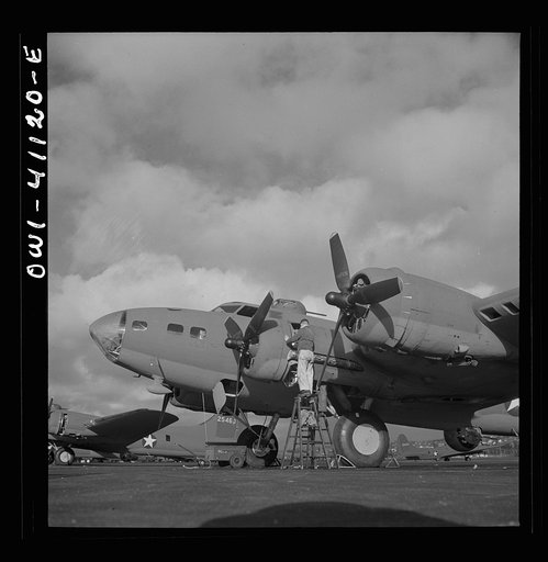 Boeing aircraft plant, Seattle, Washington. Production of B-17F (Flying Fortress) bombing planes. Lubricating and servicing a new B-17F (Flying Fortress) bombers