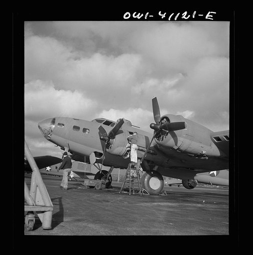 Untitled photo, possibly related to: Boeing aircraft plant, Seattle, Washington. Production of B-17F (Flying Fortress) bombing planes. Lubricating and servicing a new B-17F (Flying Fortress) bombers.