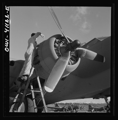 Boeing aircraft plant, Seattle, Washington. Production of B-17F (Flying Fortress) bombing planes. Lubricating and servicing a new B-17F (Flying Fortress) bomber