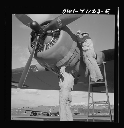 Boeing aircraft plant, Seattle, Washington. Production of B-17F (Flying Fortress) bombing planes. Lubricating and servicing a new B-17F (Flying Fortress) bomber