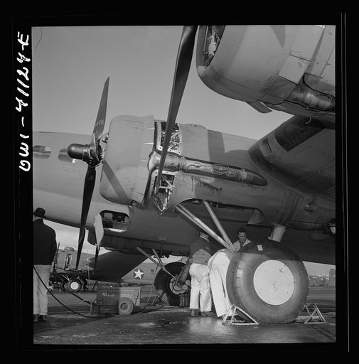 Untitled photo, possibly related to: Boeing aircraft plant, Seattle, Washington. Production of B-17F (Flying Fortress) bombing planes. Lubricating and servicing a new B-17F (Flying Fortress) bombers