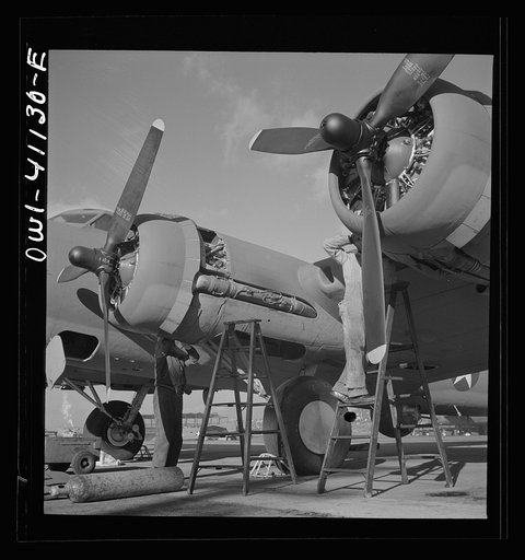 Boeing aircraft plant, Seattle, Washington. Production of B-17F (Flying Fortress) bombing planes. Lubricating and servicing a new B-17F (Flying Fortress) bombers