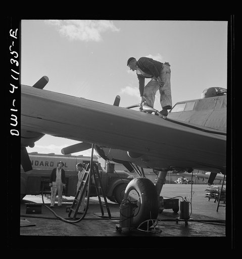Untitled photo, possibly related to: Boeing aircraft plant, Seattle, Washington. Production of B-17F (Flying Fortress) bombing planes. Fueling a B-17F (Flying Fortress) bombers.