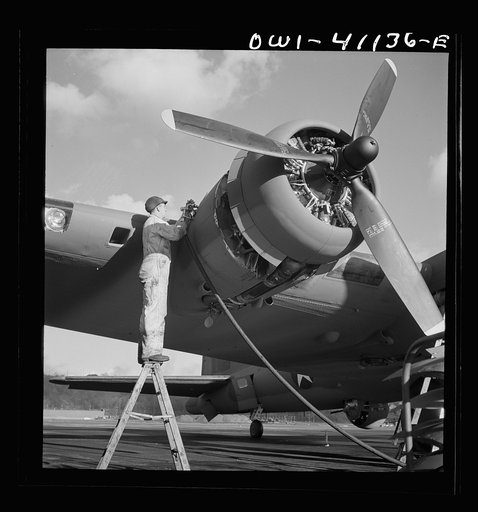 Boeing aircraft plant, Seattle, Washington. Production of B-17F (Flying Fortress) bombing planes. Lubricating and servicing a new B-17F (Flying Fortress bomber