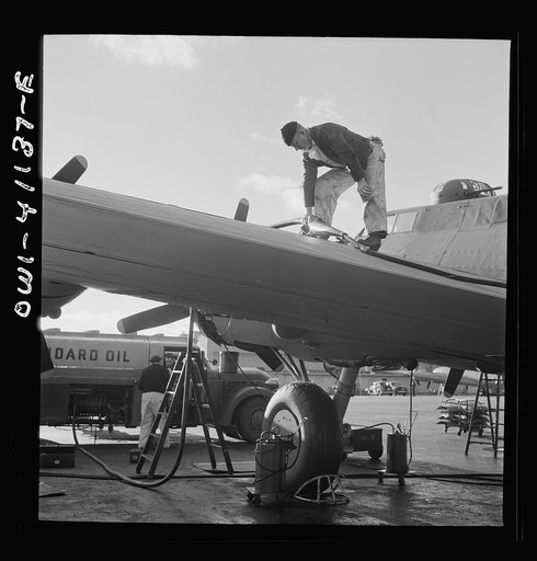 Boeing aircraft plant, Seattle, Washington. Production of B-17F (Flying Fortress) bombing planes. Fueling a B-17F (Flying Fortress) bombers