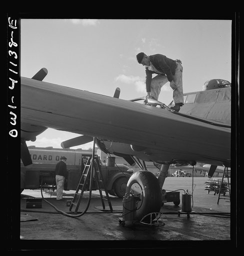 Untitled photo, possibly related to: Boeing aircraft plant, Seattle, Washington. Production of B-17F (Flying Fortress) bombing planes. Fueling a B-17F (Flying Fortress) bombers.
