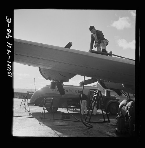 Boeing aircraft plant, Seattle, Washington. Production of B-17F (Flying Fortress) bombing planes. Fueling a B-17F (Flying Fortress) bombers