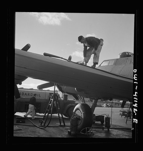 Untitled photo, possibly related to: Boeing aircraft plant, Seattle, Washington. Production of B-17F (Flying Fortress) bombing planes. Fueling a B-17F (Flying Fortress) bombers.