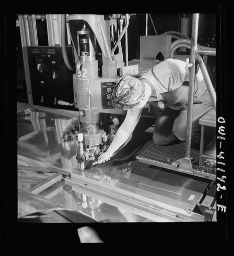 Boeing aircraft plant, Seattle, Washington. Production of B-17F (Flying Fortress) bombing planes. A spot welder