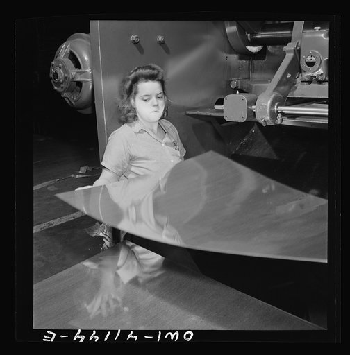 Boeing aircraft plant, Seattle, Washington. Production of B-17F (Flying Fortress) bombing planes. A sheet metal worker
