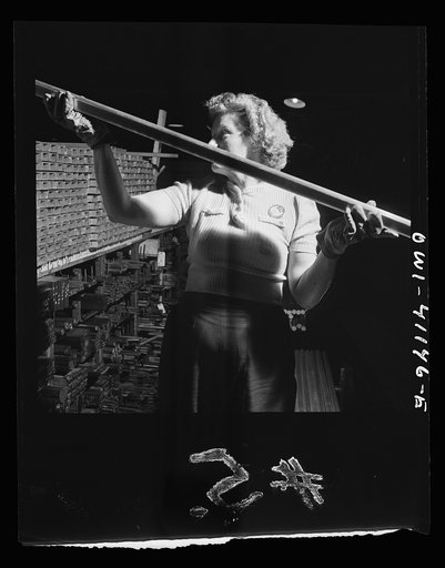 Boeing aircraft plant, Seattle, Washington. Production of B-17F (Flying Fortress) bombing planes. Warehouse worker handing out material for the building of B-17F (Flying Fortress) bombers