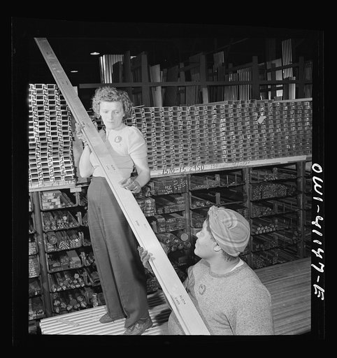 Untitled photo, possibly related to: Boeing aircraft plant, Seattle, Washington. Production of B-17F (Flying Fortress) bombing planes. Warehouse handing out material for the building of B-17F (Flying Fortress) bombers