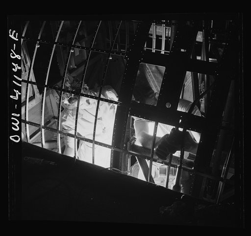 Boeing aircraft plant, Seattle, Washington. Production of B-17F (Flying Fortress) bombing planes. Workers constructing the fuselage framework for a B-17F (Flying Fortress) bomber