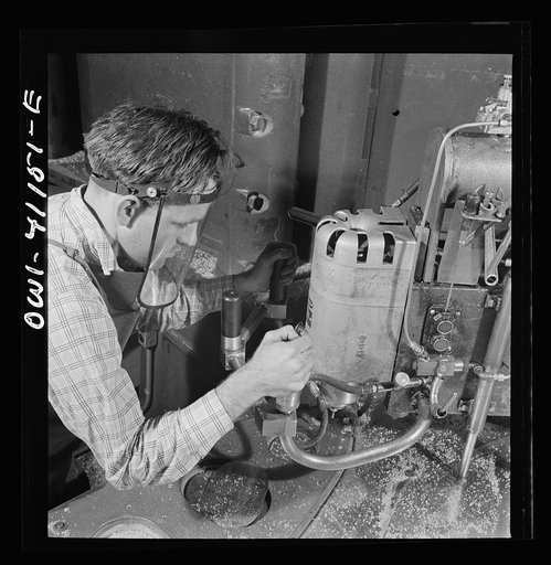 Boeing aircraft plant, Seattle, Washington. Production of B-17F (Flying Fortress) bombing planes. Worker operating a routing machine which uses metal template as a guide to make wood patterns. In the early stage of development wood supplements metal in the construction of a B-17F (Flying Fortress) b