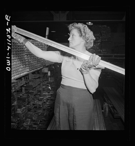 Untitled photo, possibly related to: Boeing aircraft plant, Seattle, Washington. Production of B-17F (Flying Fortress) bombing planes. Warehouse worker handing out material for the building of B-17F (Flying Fortress) bombers.