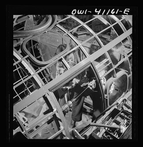 Boeing aircraft plant, Seattle, Washington. Production of B-17F (Flying Fortress) bombing planes. Assembly and fitting operations on the interior of a fuselage section