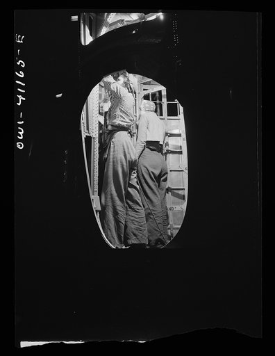 Boeing aircraft plant, Seattle, Washington. Production of B-17F (Flying Fortress) bombing plane. Assembly and fitting operations on the interior of a fuselage section for a B-17F (Flying Fortress) bomber