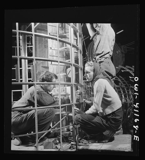 Untitled photo, possibly related to: Boeing aircraft plant, Seattle, Washington. Production of B-17F (Flying Fortress) bombing planes. Assembly and fitting operations on the interior of a fuselage section