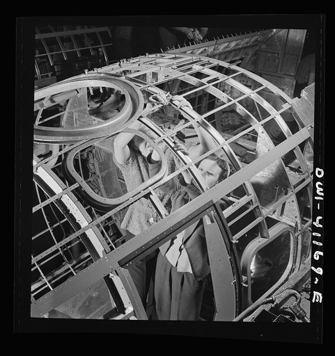 Boeing aircraft plant, Seattle, Washington. Production of B-17 (Flying Fortress) bombing planes. Women working to complete a fuselage production