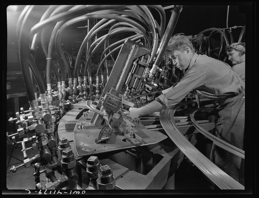 Boeing aircraft plant, Seattle, Washington. Production of B-17 (Flying Fortress) bombing planes. Octupus punching machine working on parts for B-17 (Flying Fortress) bombers