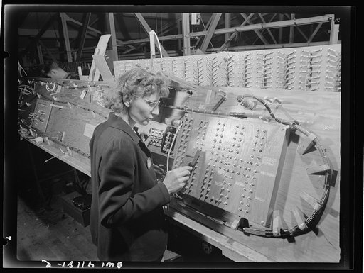 Boeing aircraft plant, Seattle, Washington. Production of B-17 (Flying Fortress) bombing planes. Girl checking electrical wiring assemblies