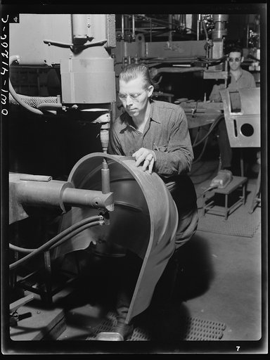 Untitled photo, possibly related to: Boeing aircraft plant, Seattle, Washington. Production of B-17 (Flying Fortress) bombing planes. An electric spot welding job for a B-17 (Flying Fortress) bomber