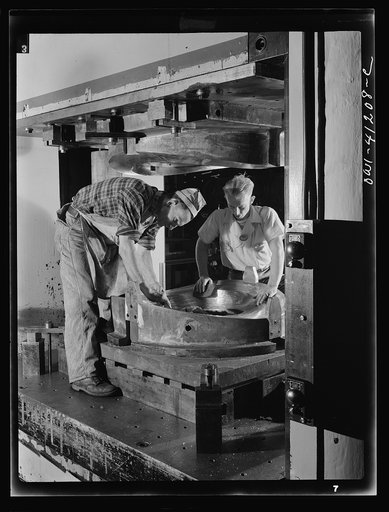 Boeing aircraft plant, Seattle, Washington. Production of B-17 (Flying Fortress) bombing planes. Kirksite dies for the forming of parts of the B-17 (Flying Fortress). Bombers are being finished in a hydraulic press